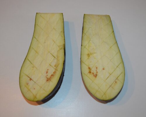 Cut the flesh of the eggplant halves