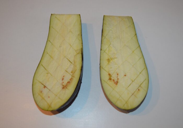 Cut the flesh of the eggplant halves