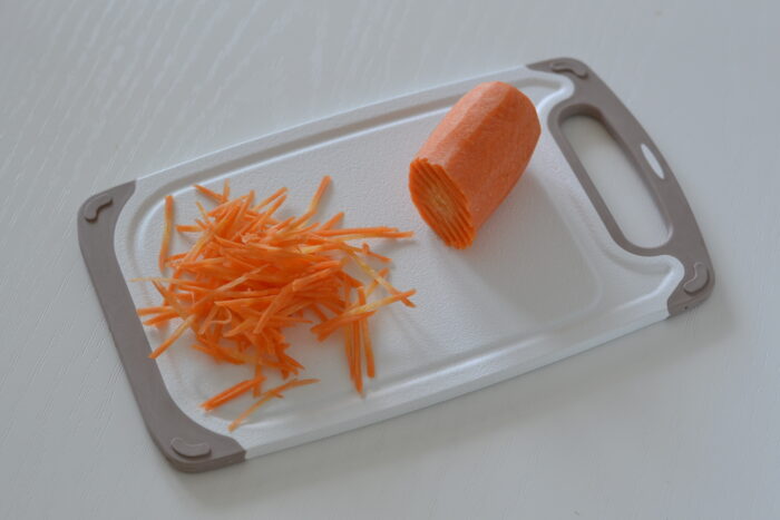 Peel the carrots and grate them using a Korean carrot grater