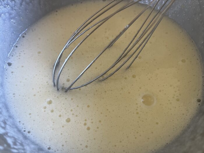 Lightly beat the eggs with the sugar