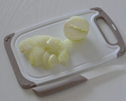 Peel the onion and cut it into quarter rings