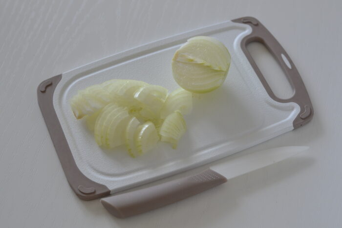 Peel the onion and cut it into quarter rings