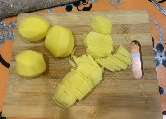 Peel the potatoes and cut