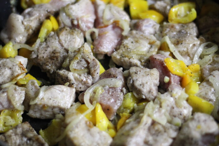 Add the pork to the vegetables and fry