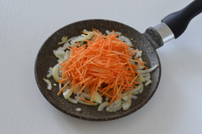 Add the grated carrots to the pan