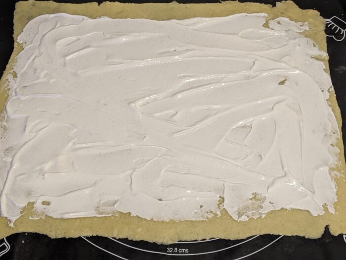 Spread the cream mixture over the dough
