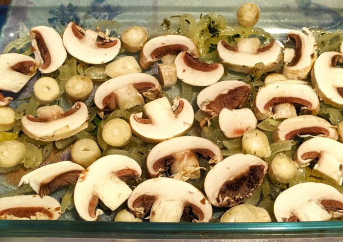 Place half of the onions and mushrooms