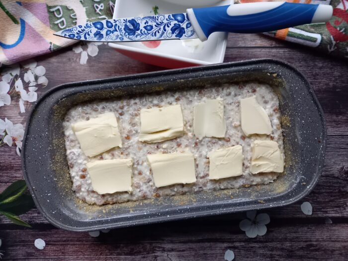 Spread thin slices of butter on top