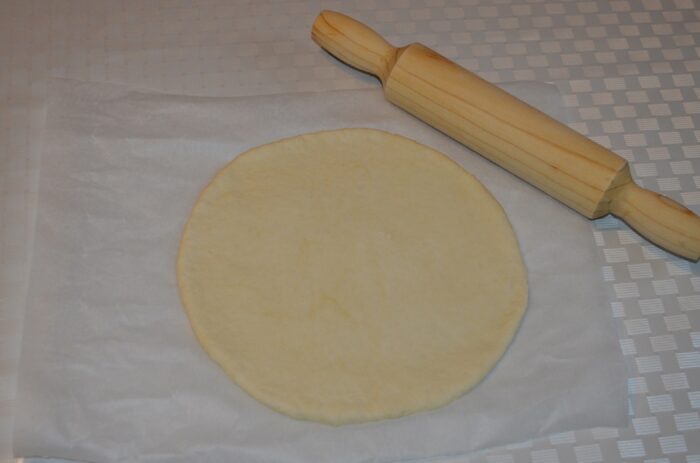 roll out the dough into a round shape