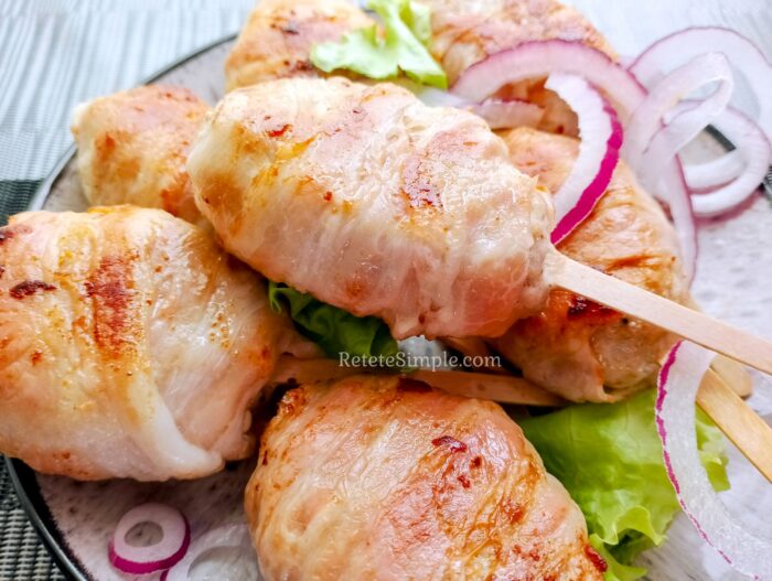 Bacon-wrapped patties fresh from the pan