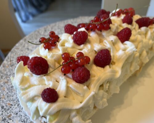 Decorate the top with raspberries and currant branches