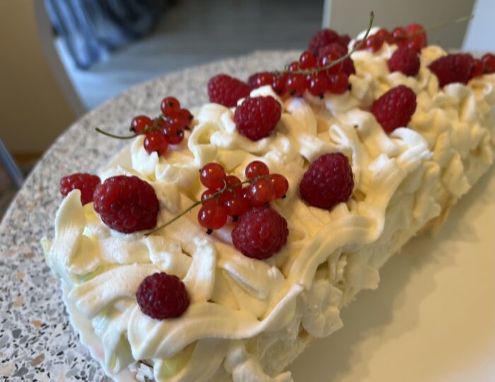 Decorate the top with raspberries and currant branches