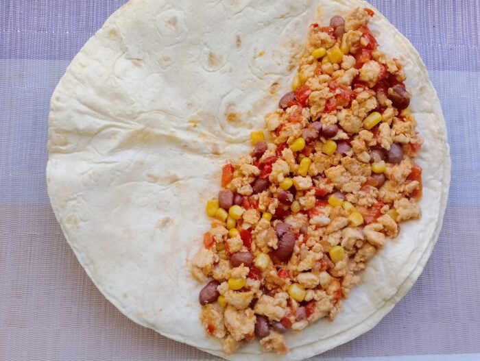 Spread the cheese over half of the tortilla