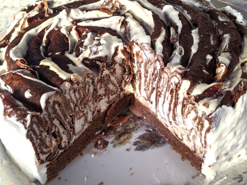 Crepe cake on a cake stand with cream filling visible between layers