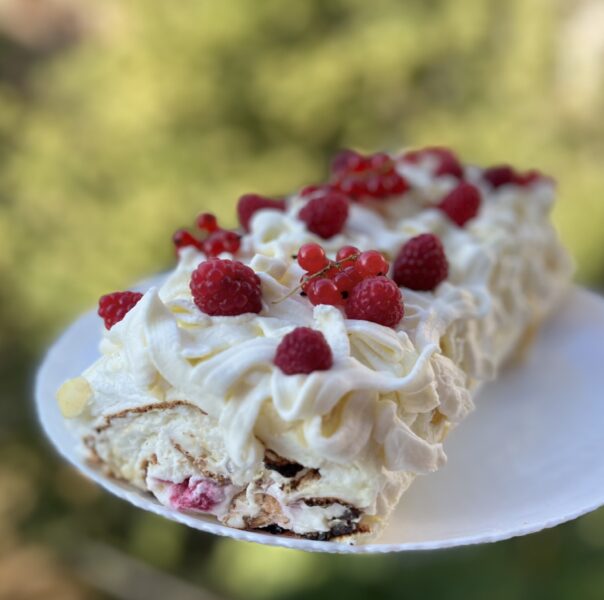 Meringue roll with raspberries and pistachios
