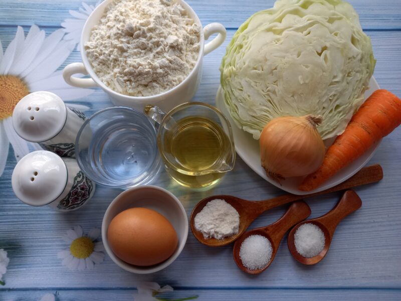 Ingredients laid out: cabbage, onions, pastry dough, spices