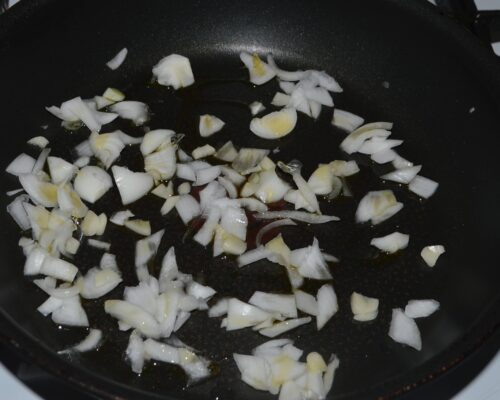 Add the chopped onion and garlic to a pan