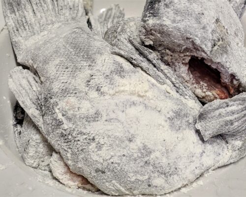 Coat each piece of fish thoroughly in flour