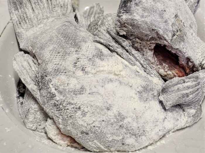 Coat each piece of fish thoroughly in flour