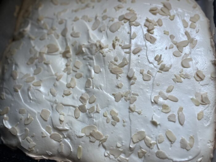 Sprinkle the top generously with almond petals