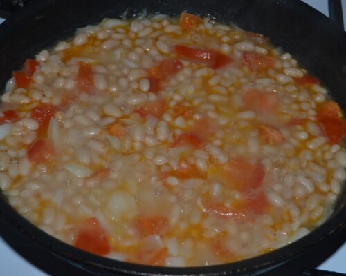 Add the cooked beans to the pan