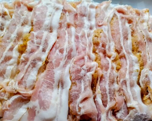 Cut the meat along the bacon slices
