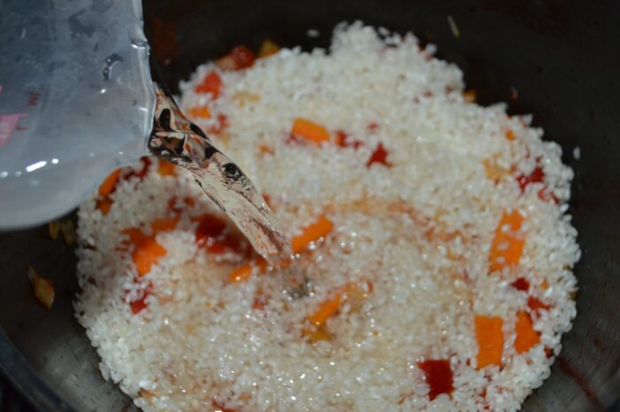 Pour in enough water to cover the rice