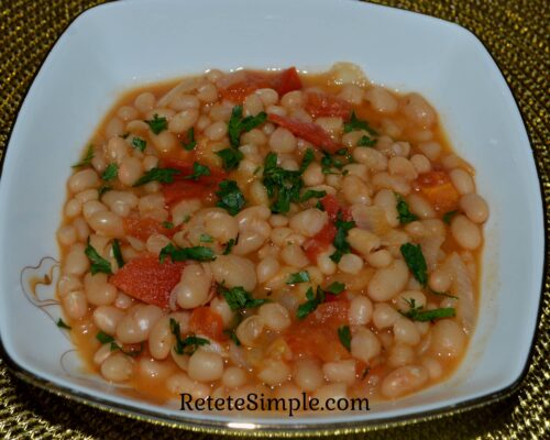 Bowl of bean stew with vegetables and parsley on top