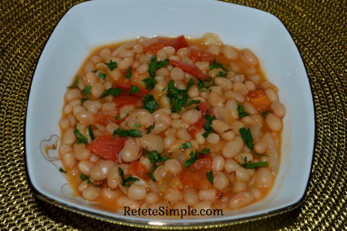 Bowl of bean stew with vegetables and parsley on top