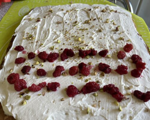 Sprinkle with chopped pistachios and arrange a row of berries