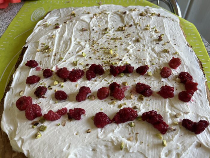 Sprinkle with chopped pistachios and arrange a row of berries