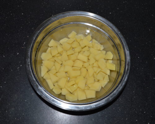 Peel the potatoes and cut them into cubes