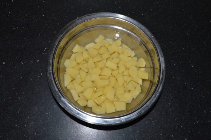 Peel the potatoes and cut them into cubes