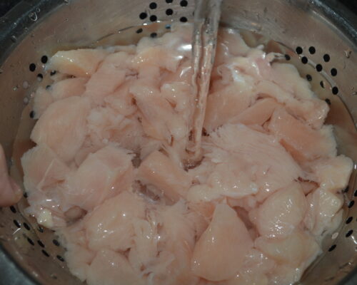 Place the chopped chicken breast in a colander