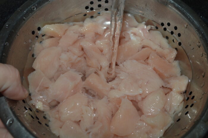 Place the chopped chicken breast in a colander