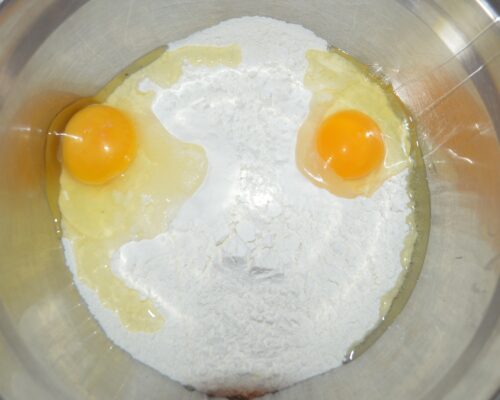 Add the eggs to the flour