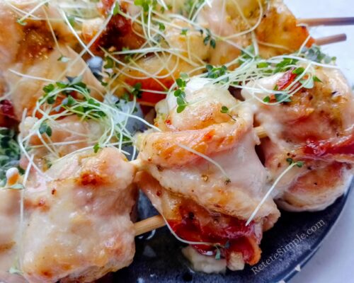 chicken bacon skewers showing golden bacon and juicy chicken