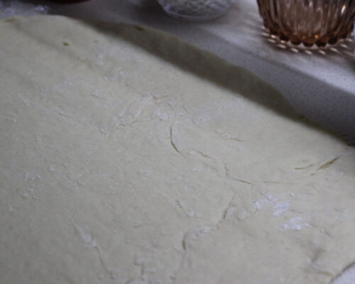 Roll out the risen yeast dough