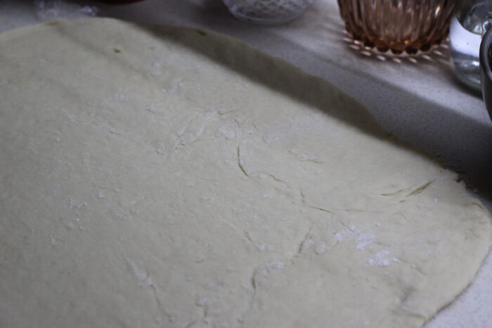 Roll out the risen yeast dough