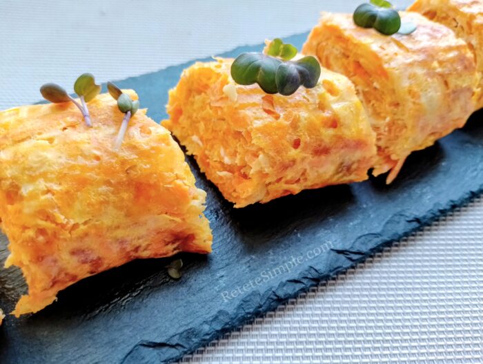 Close-up of zucchini carrot roulade slice showing melted cheese inside