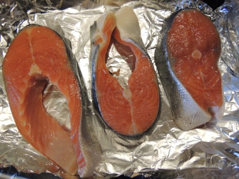 salmon fillet slices on foil
