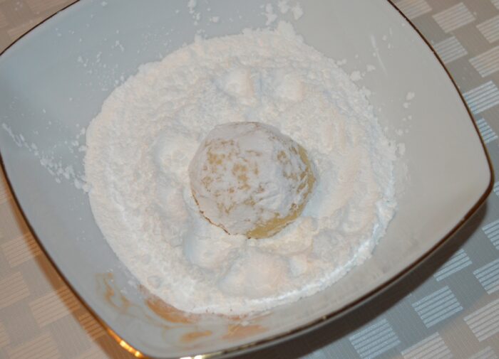 Roll the balls in powdered sugar