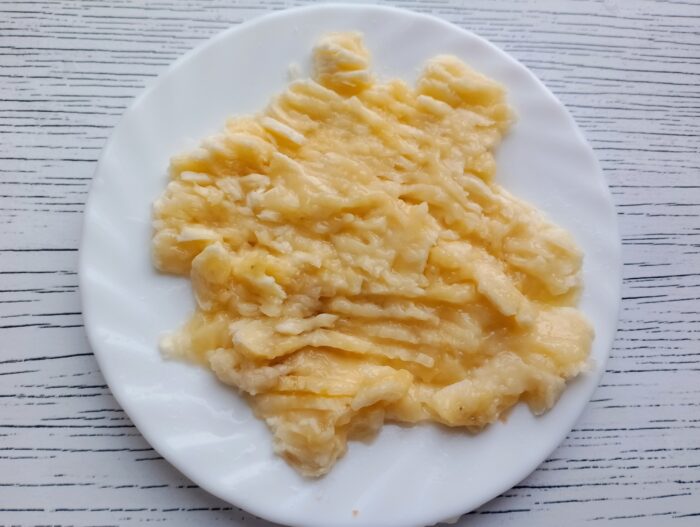 Peel the banana then mash it