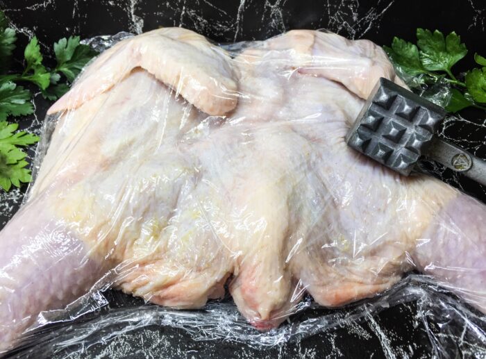 Beat the chicken with a kitchen mallet