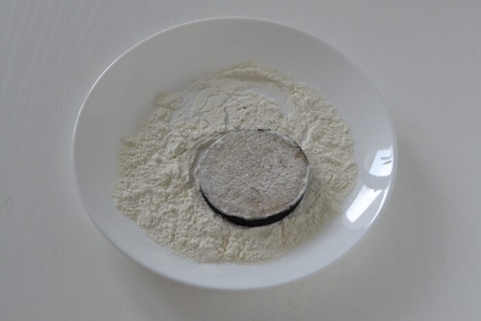 Coat the eggplant slices in flour