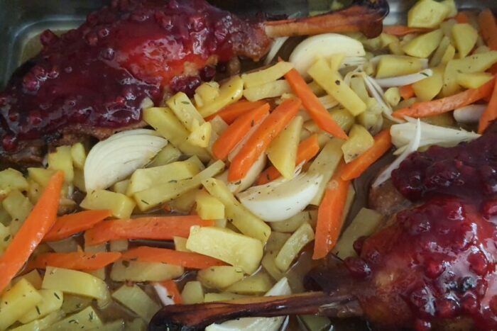 Brush the duck legs generously with the blueberry jam